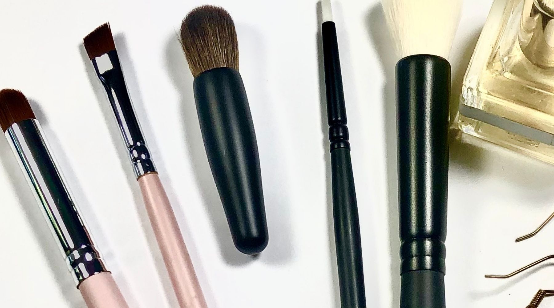eye makeup brushes and perfume bottle