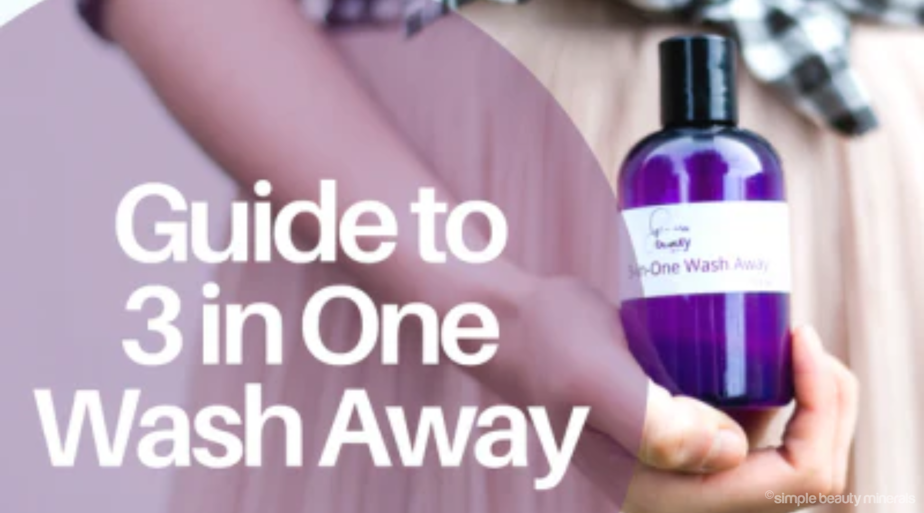 woman's hand holding a purple bottle of micellar water.