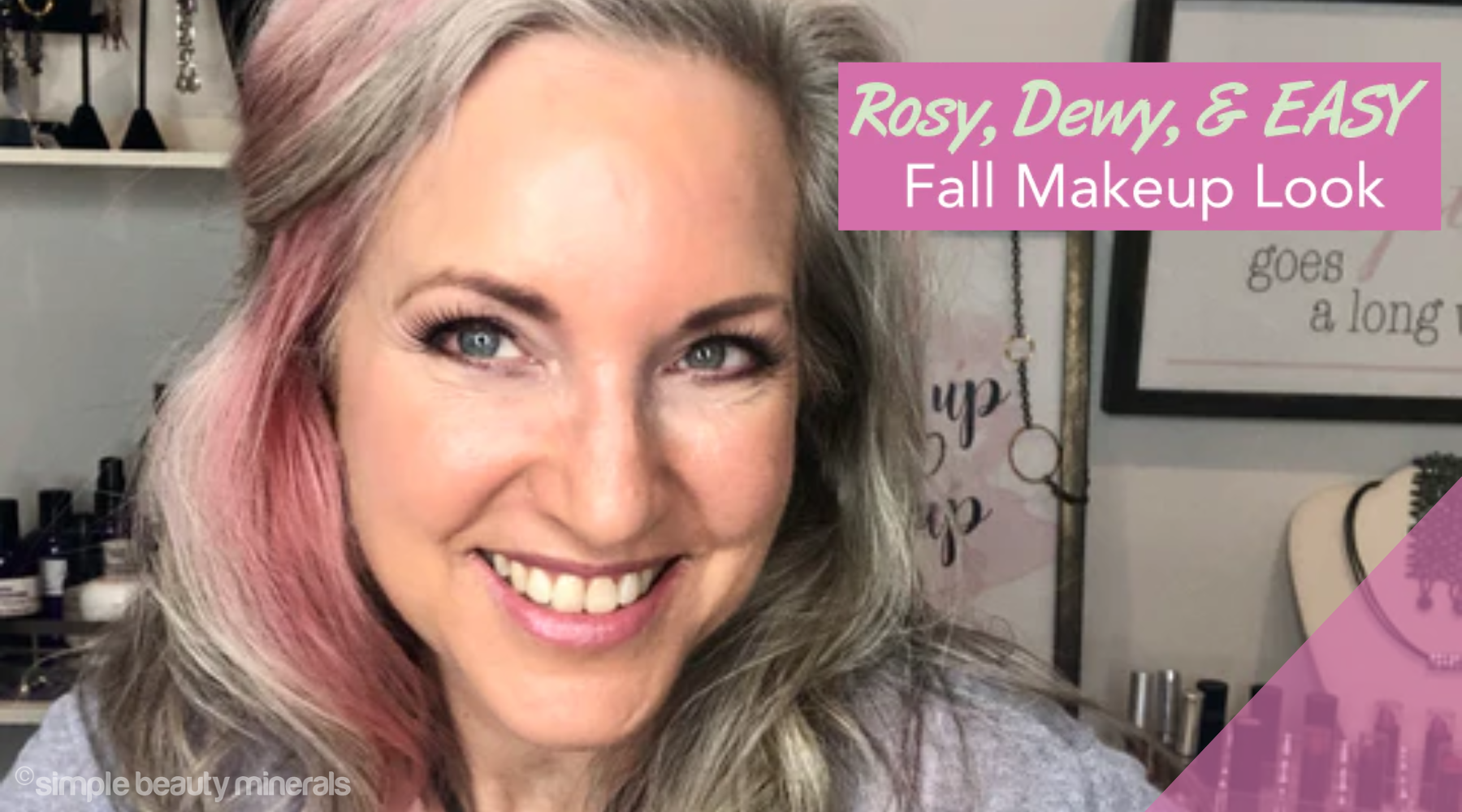 smiling woman with rosy, dewy fall makeup look.
