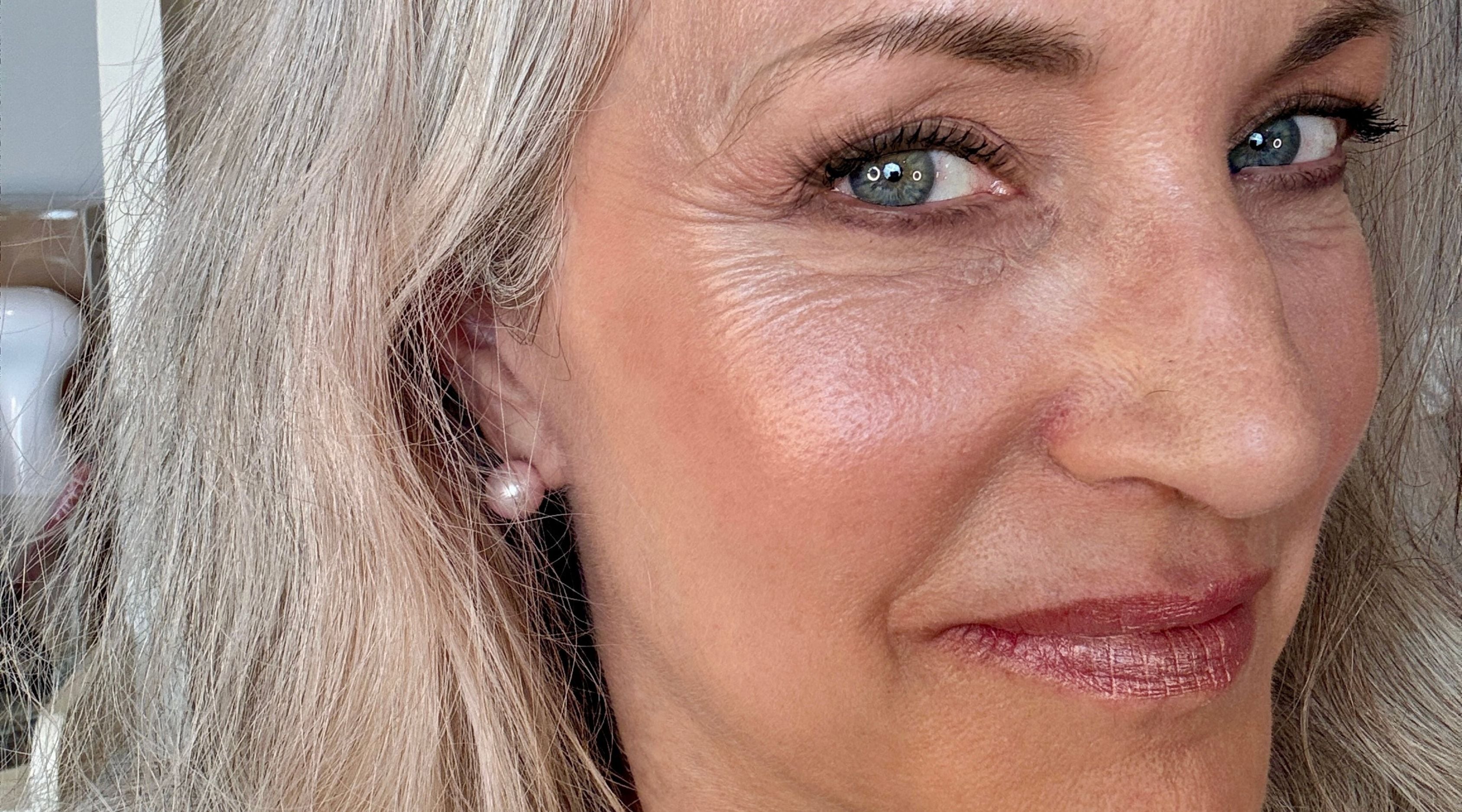 woman smiling silver hair makeup.