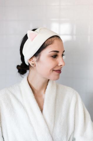 young woman in robe ready to wash face