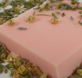 pink mineral cleansing bar sprinkled with soothing chamomile