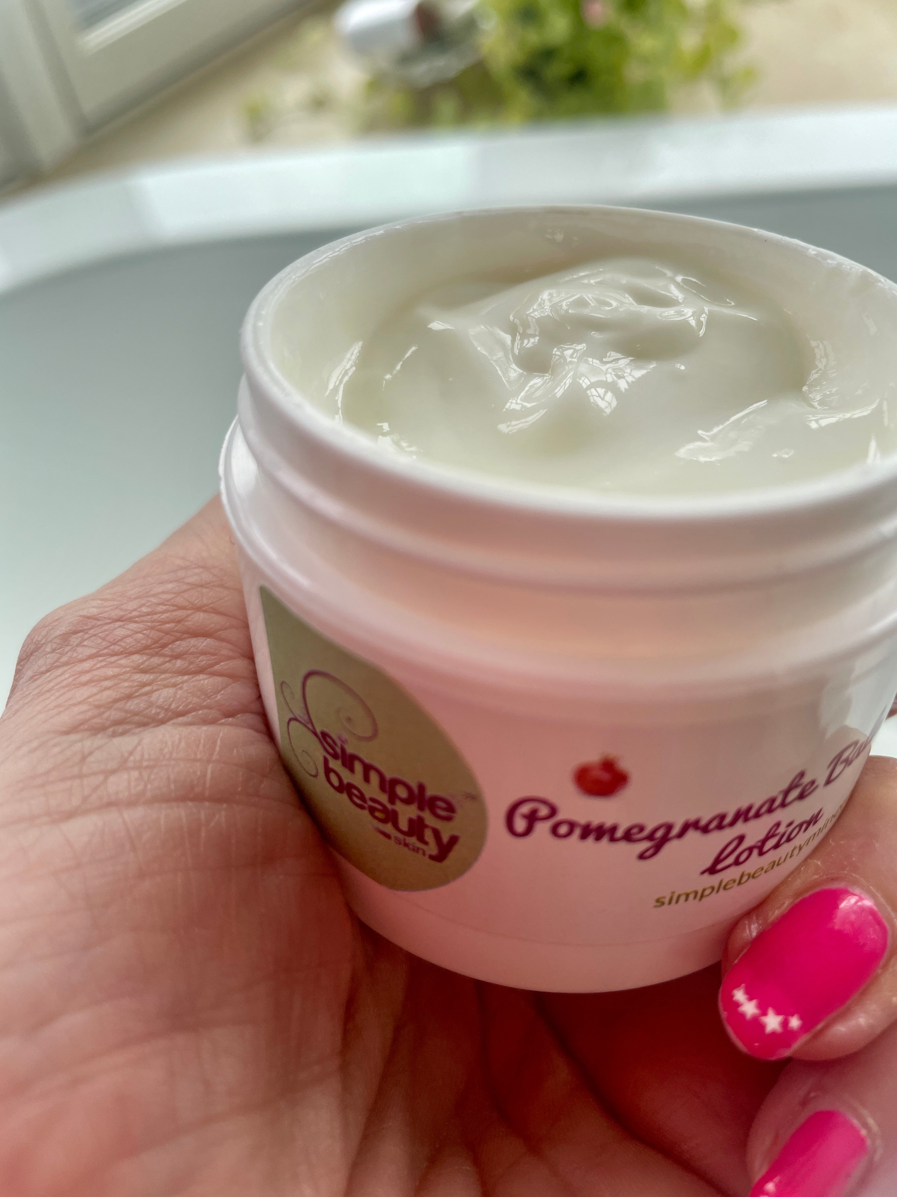 open jar of cream in hand.