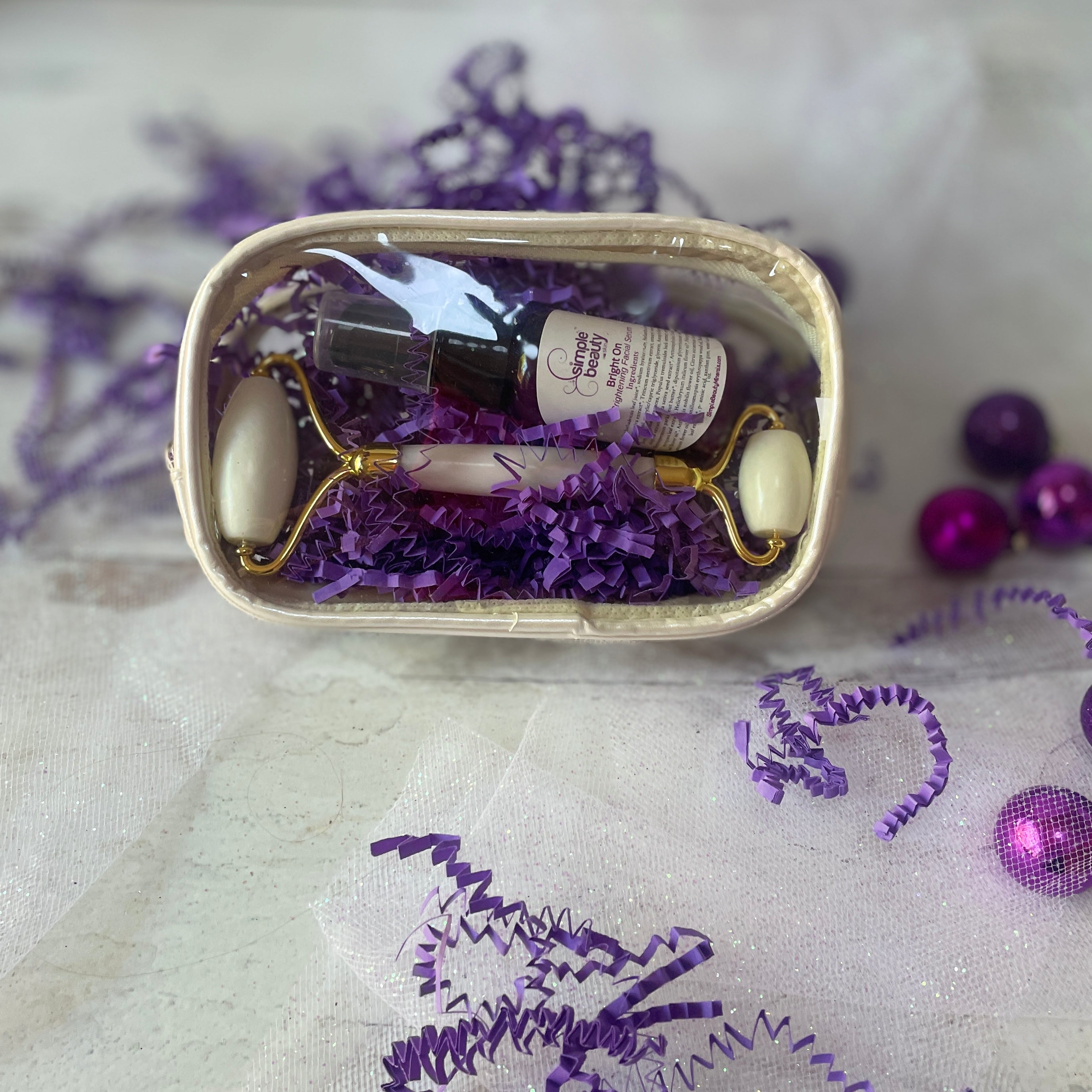 holiday gift set with serum and white jade roller.