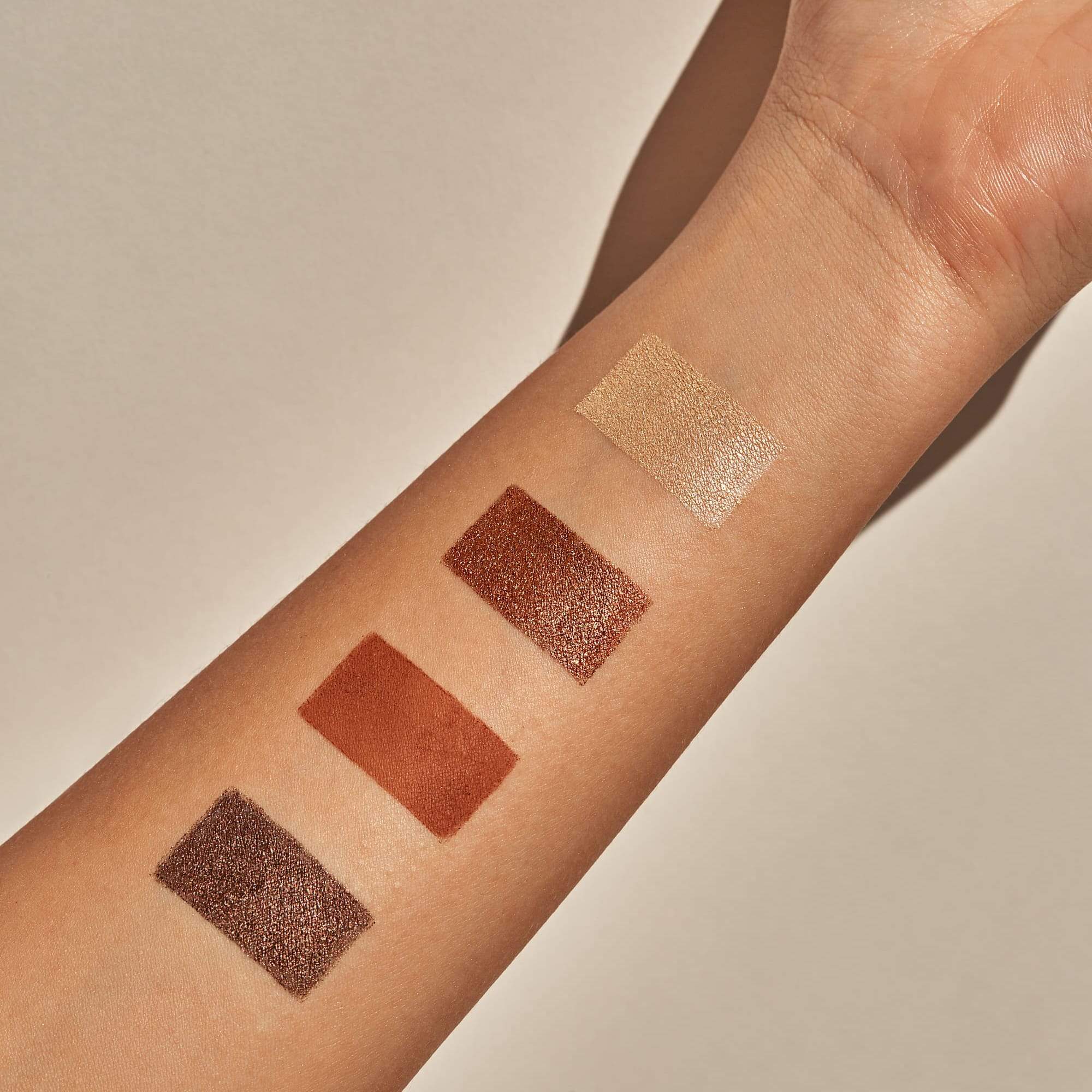 swatch of 4 eyeshadows on arm.