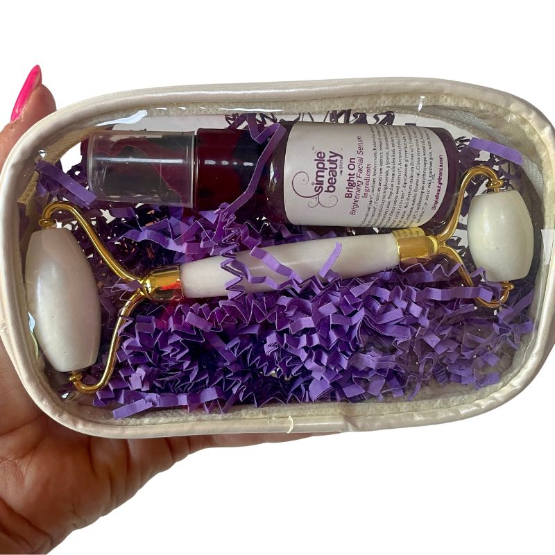white jade roller and serum in a holiday package