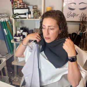 customer holding fabric color drapes up to skin makeup