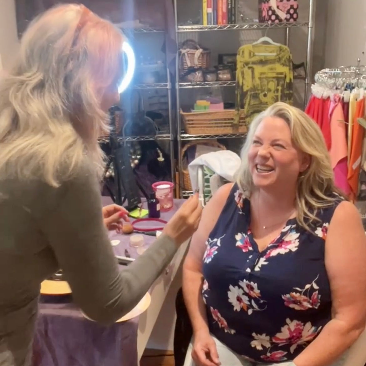 customer laughing with makeup artist