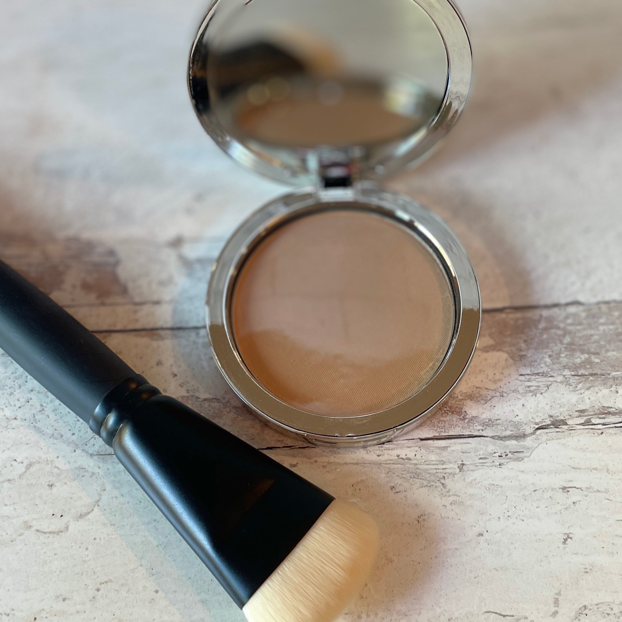 tan beige pressed powder with contour bronzing brush