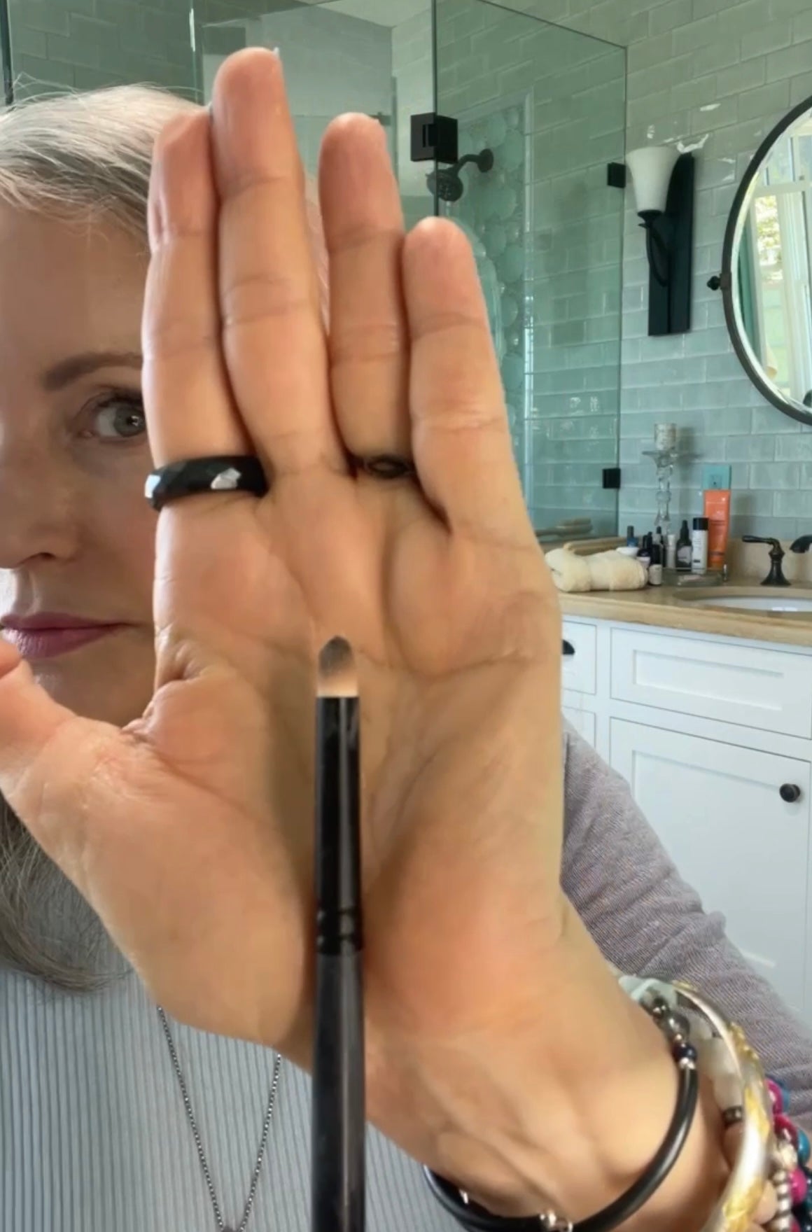 owner simple beauty minerals showing smudge brush in front of hand