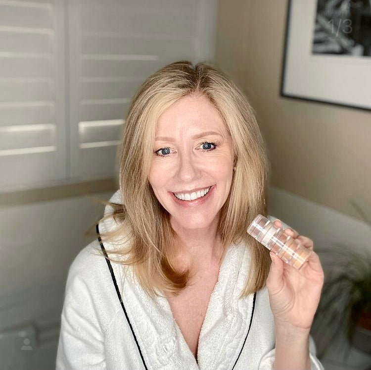woman in her bathrobe holding eyeshadow palette