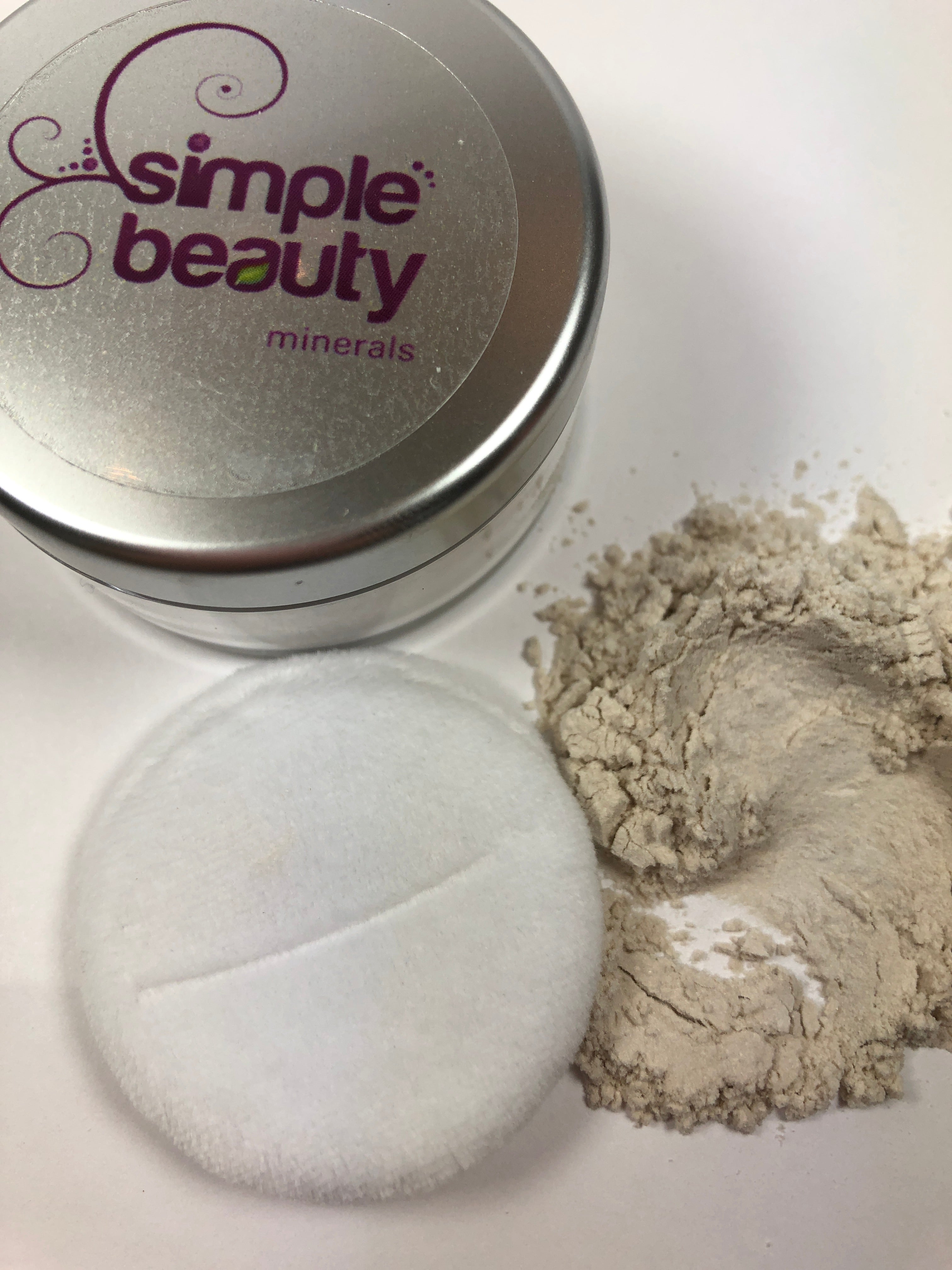 silver jar with powder and puff