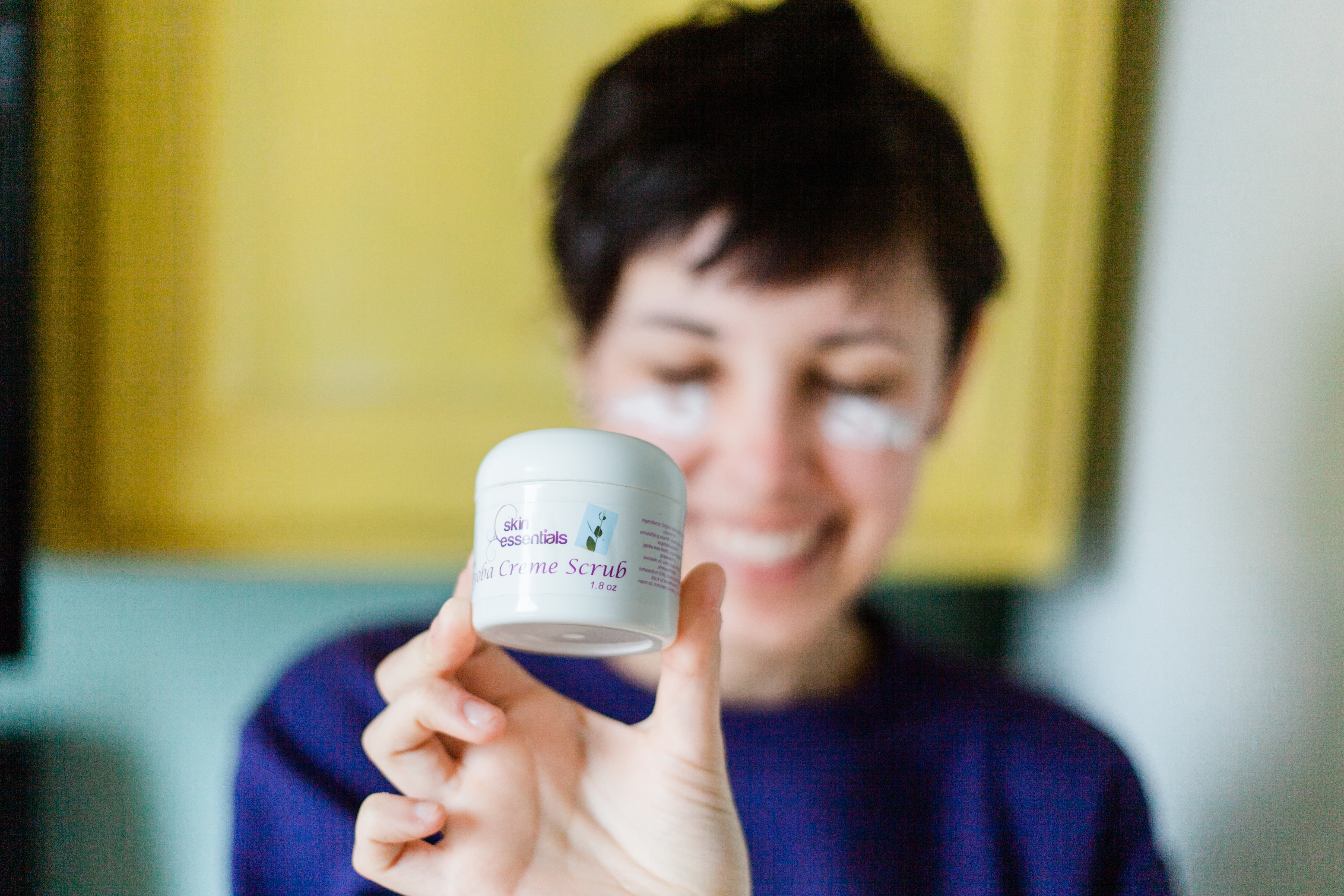 woman holding jar of scrub