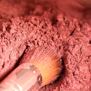 adobe mineral blush and brush dipped in pigment