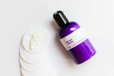 purple lotion cleanser with cotton pads
