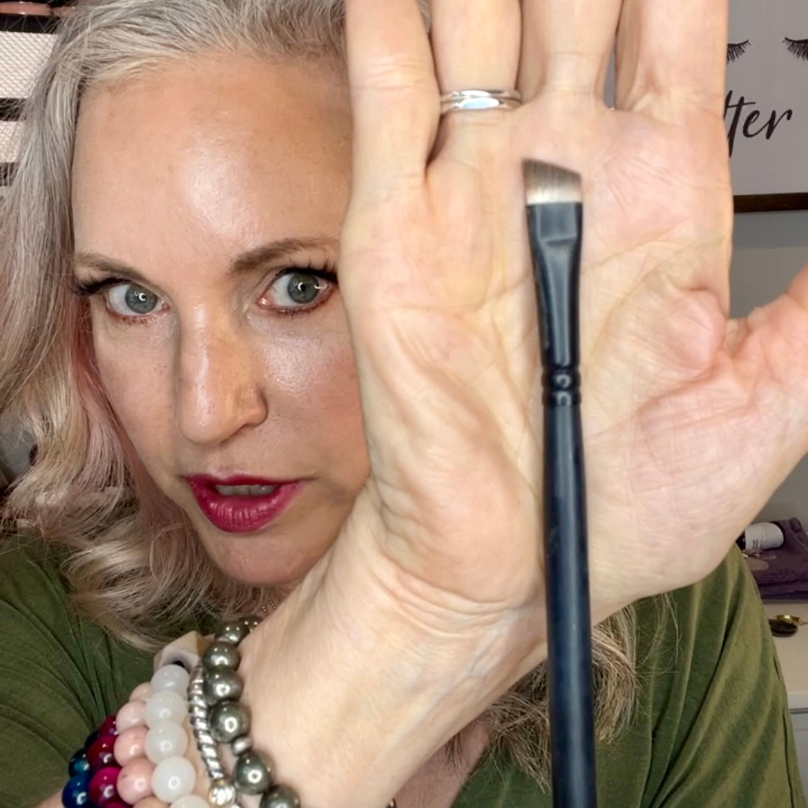 owner of simple beauty minerals holding brow brush