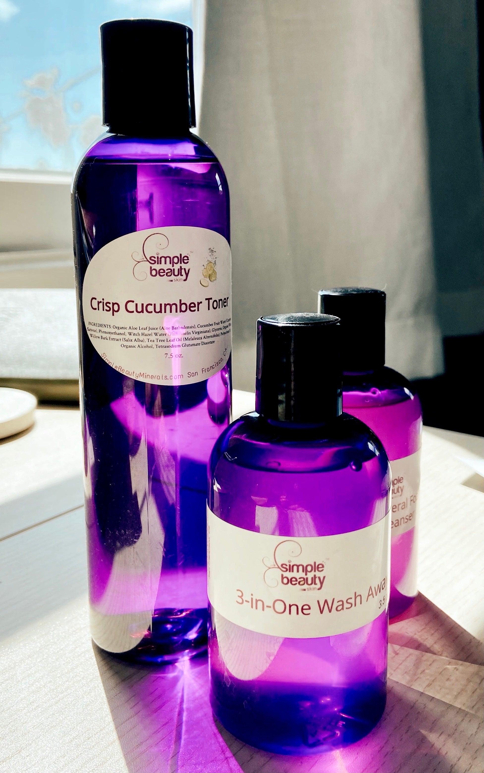 purple skincare bottles with sunlight shining