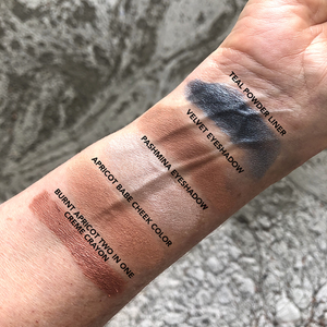 swatch of apricot babe cheek color, burnt apricot lip crayon and 3 eyeshadows