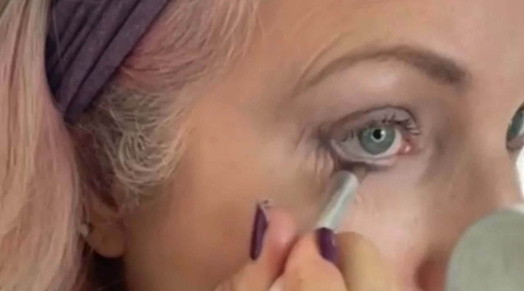 woman applying eye makeup