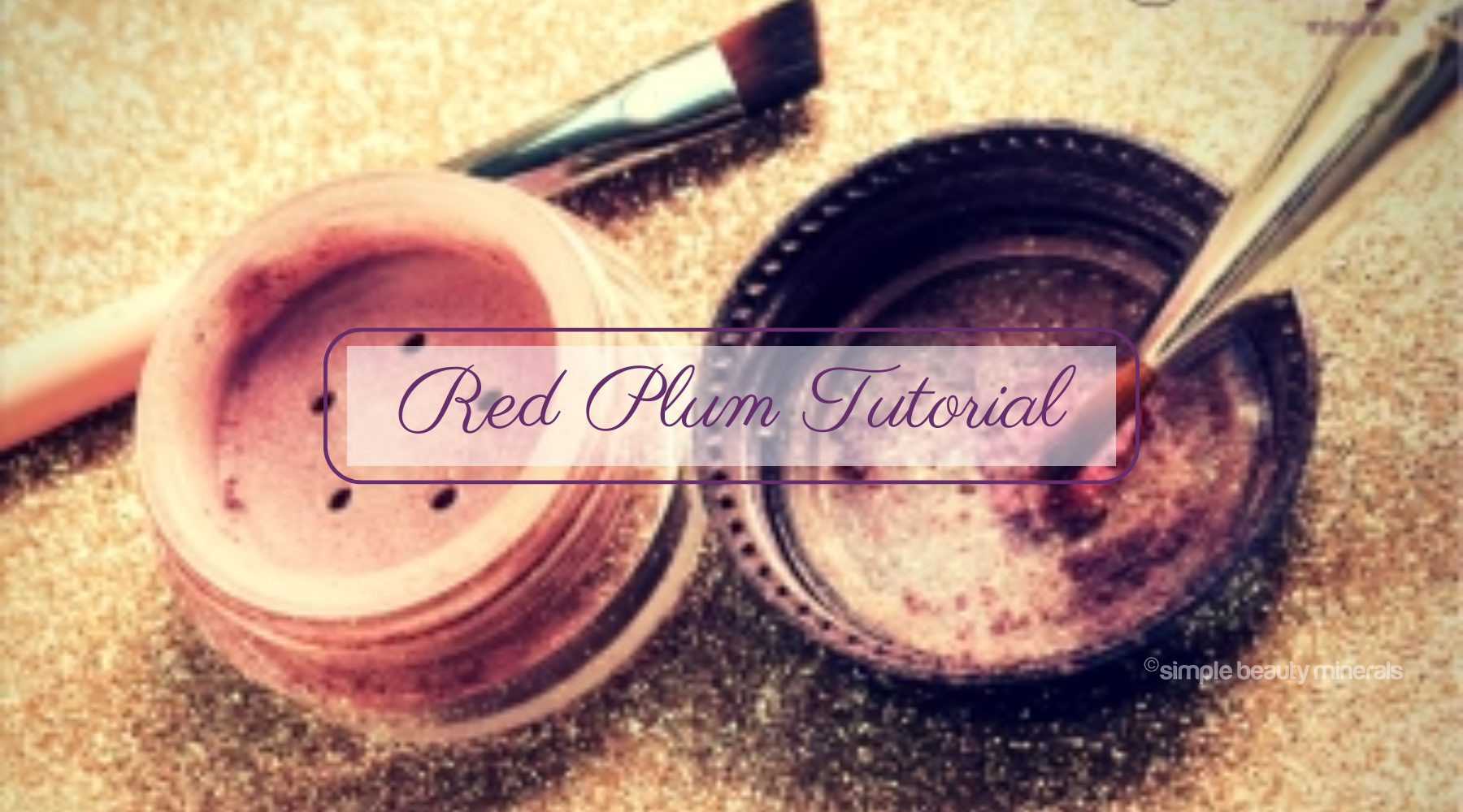 open tub of Red Plum mineral eyeshadow and makeup brushes.