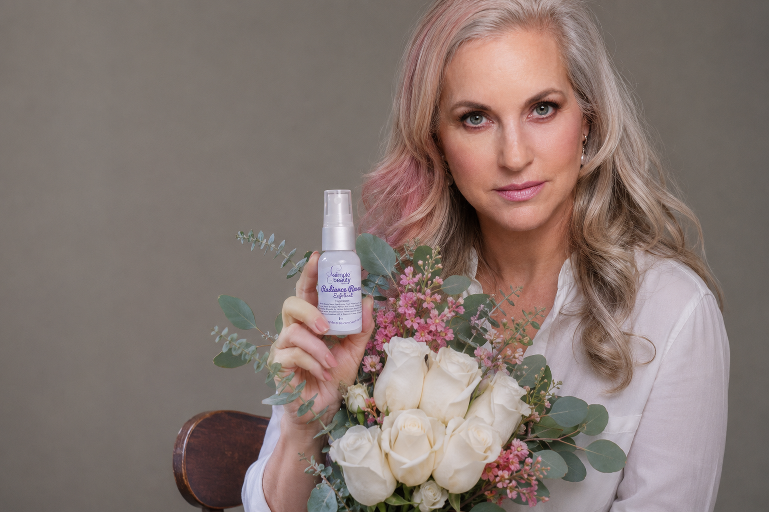 woman facial serum and flowers.