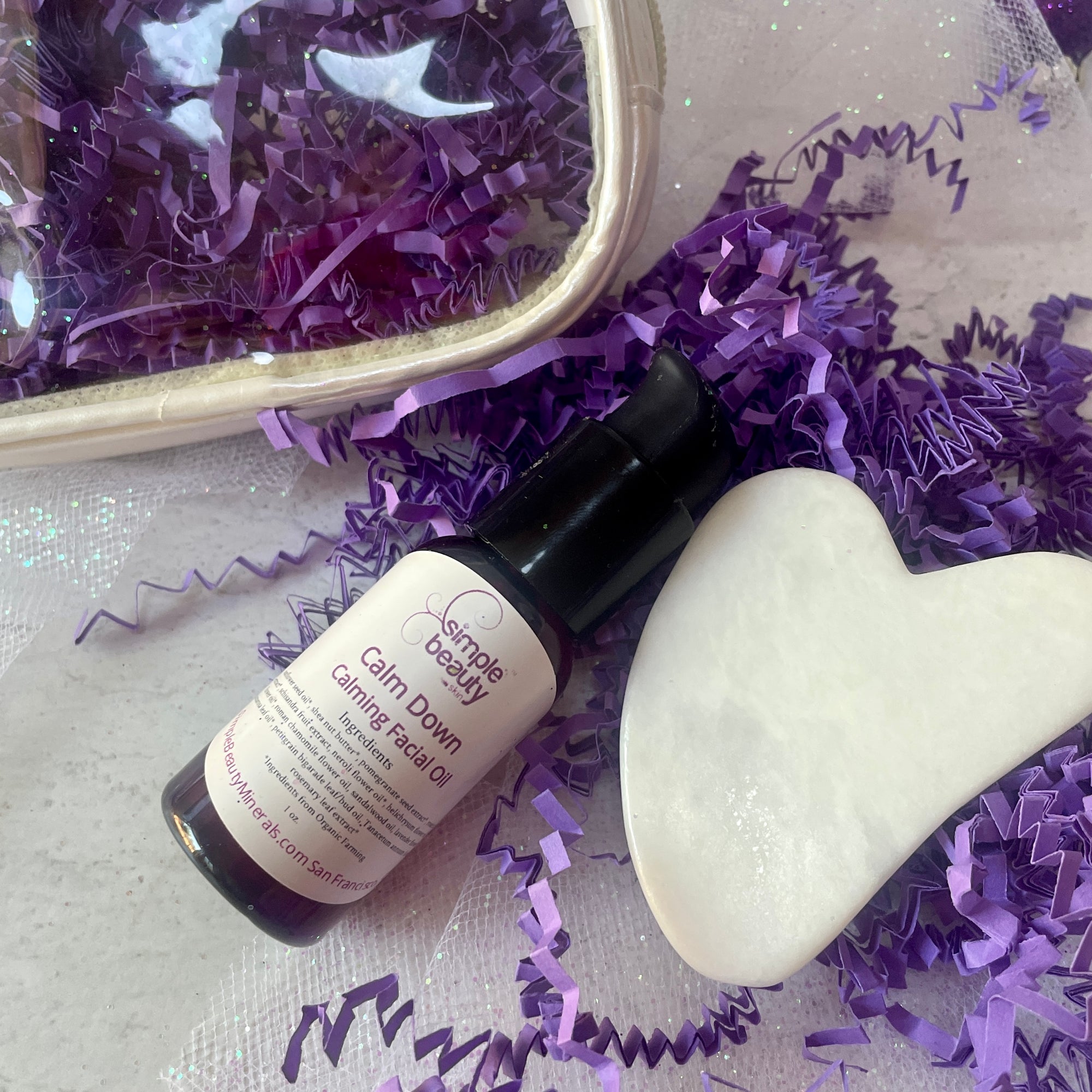 holiday image of calm down oil and gua sha.