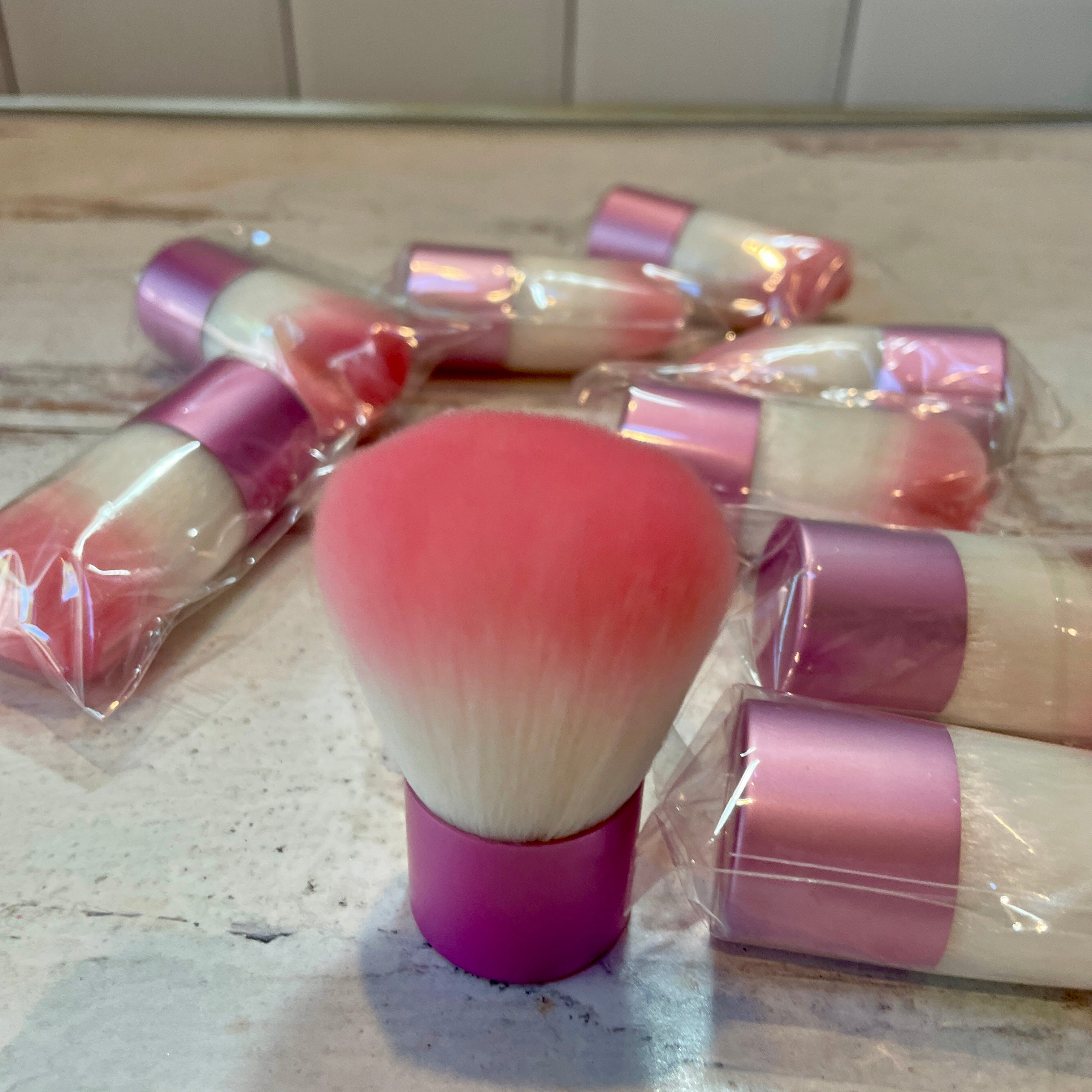 collection of pink kabuki brushes.