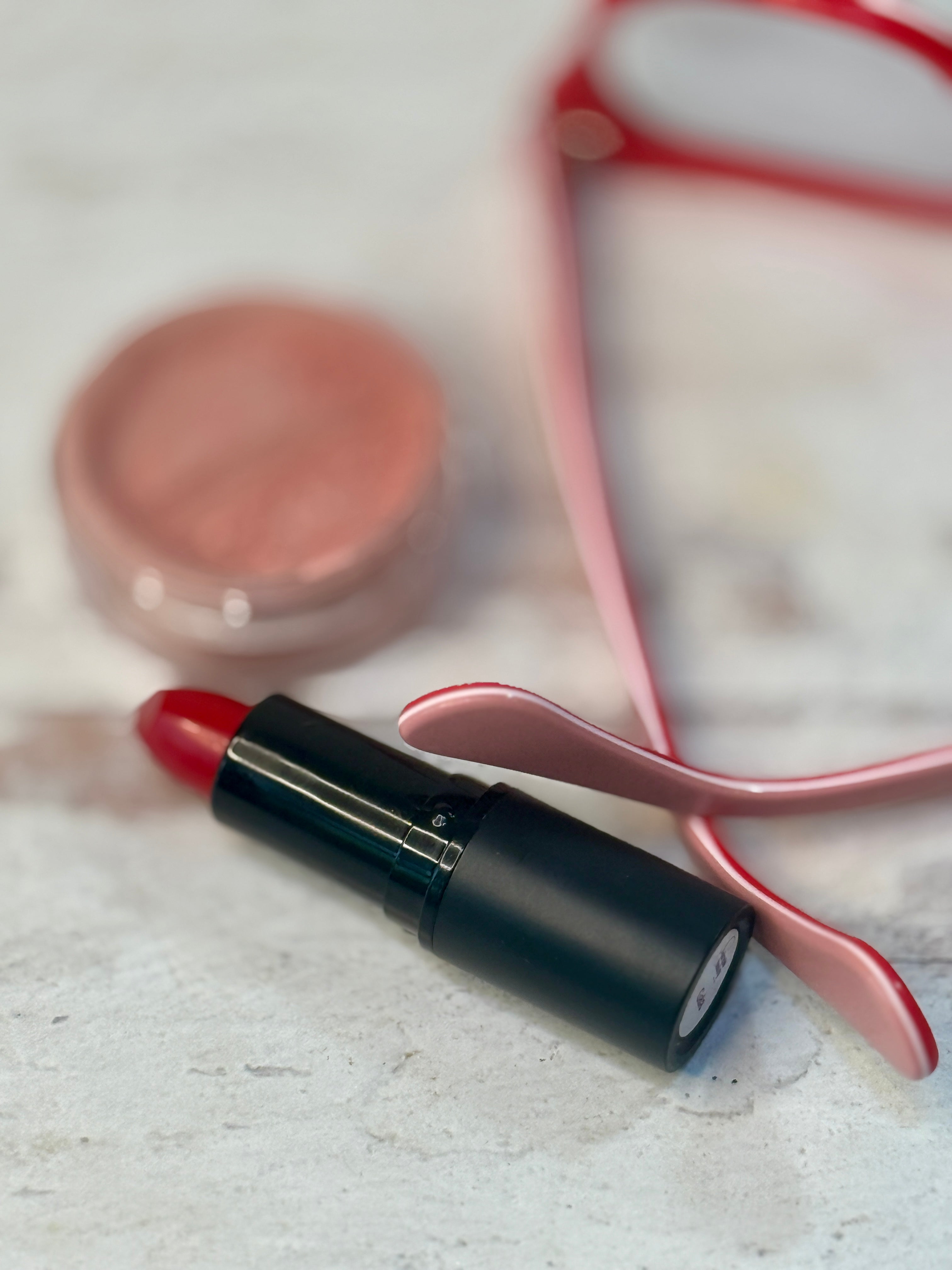 gala mineral red lipstick with blush and glasses.