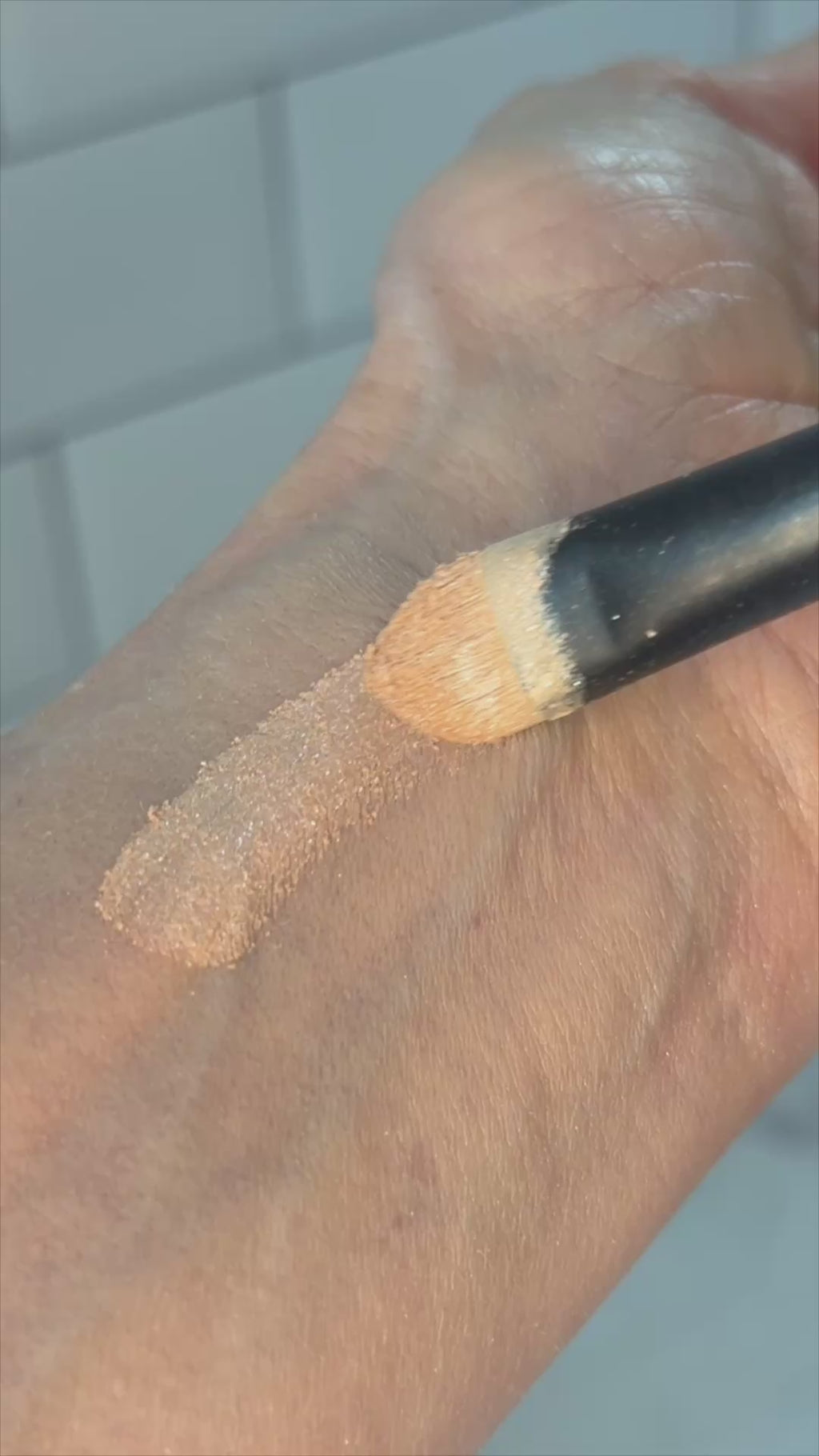 champagne eyeshadow brushed onto wrist.
