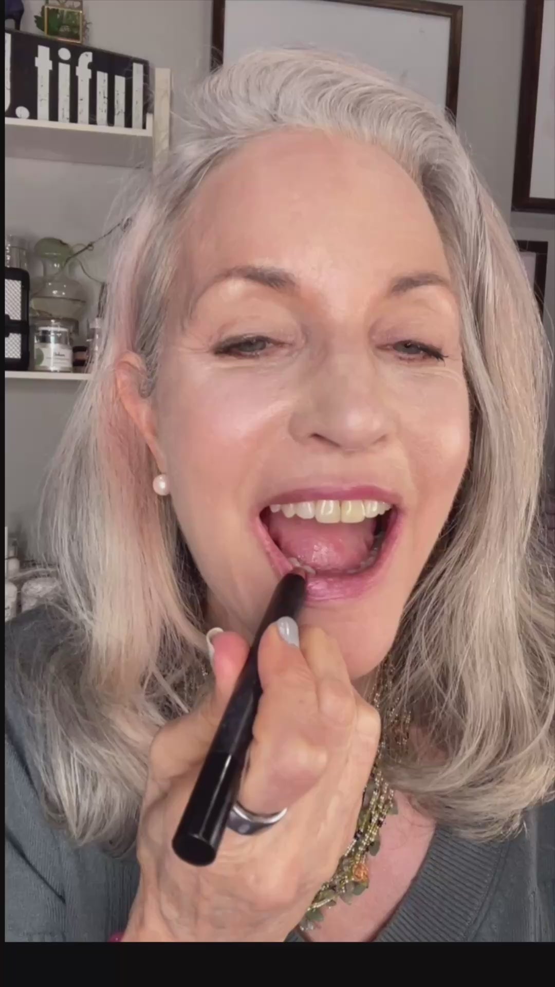 woman applying rose gold lip, cheek and eye pencil.