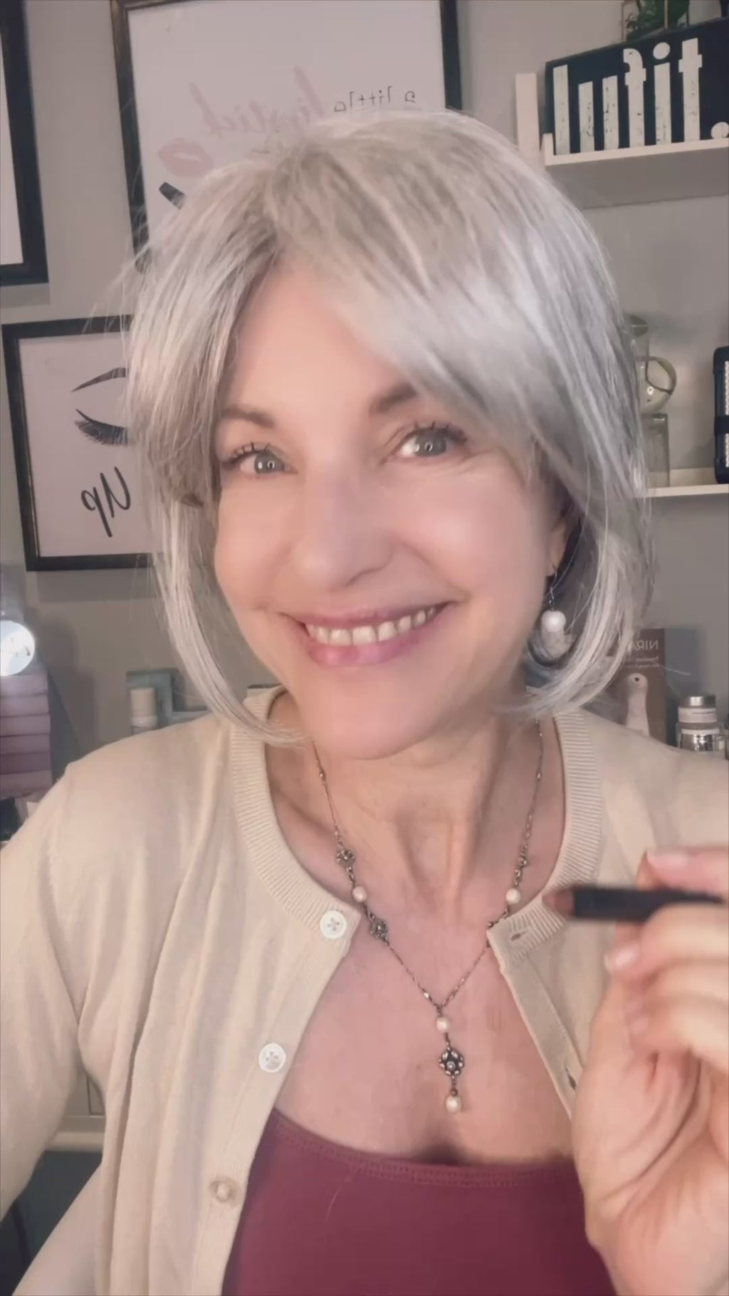 mature woman applying multitasking makeup stick.