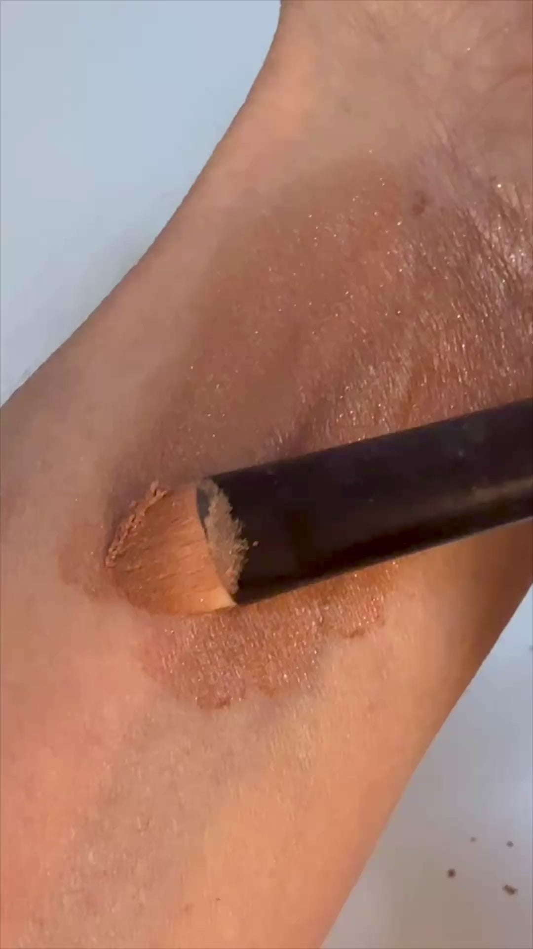 toffee mineral eyeshadow brushed on skin.