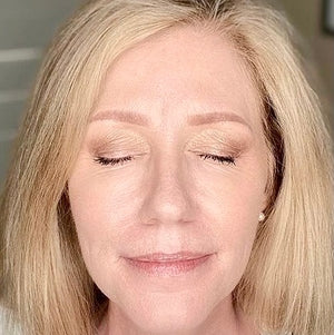 woman closed eyes wearing neutral eyeshadow makeup