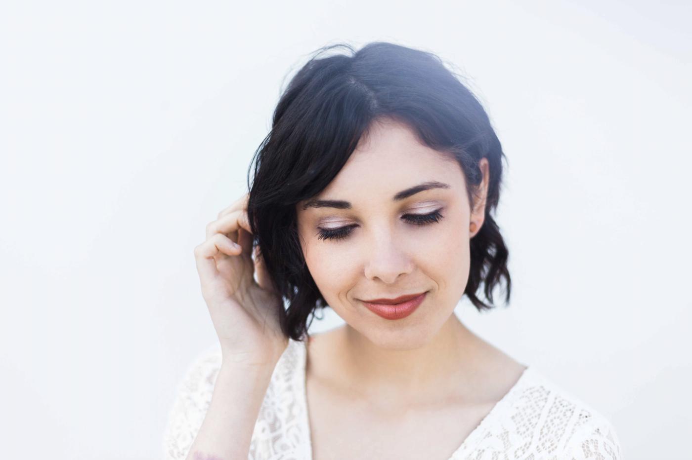 young woman with sumac lipstick, white dress