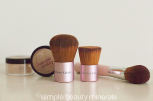 makeup jars with pink makeup brushes