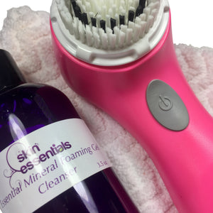 cleanser in purple bottle with pink sonic cleansing brush