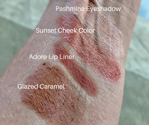 makeup palette swatch on skin one of which is glazed caramel lip crayon