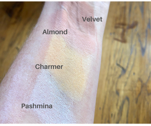 eyeshadow swatch on arm one of which is Charmer